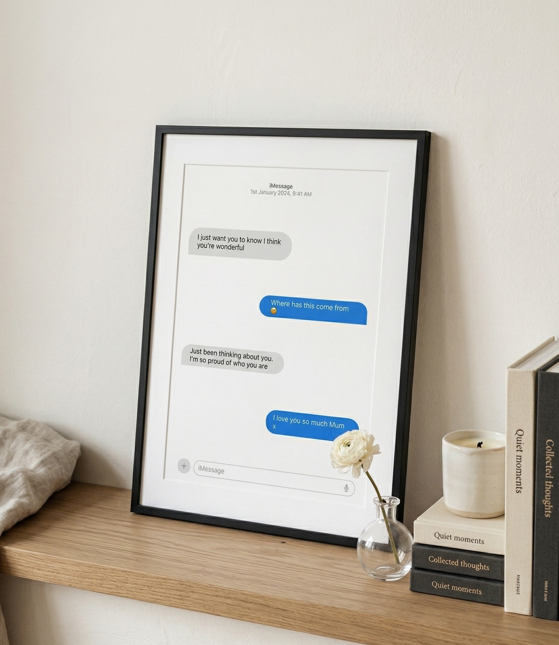Framed text message print on a shelf with decor items
