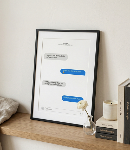 Framed text message print on a shelf with decor items