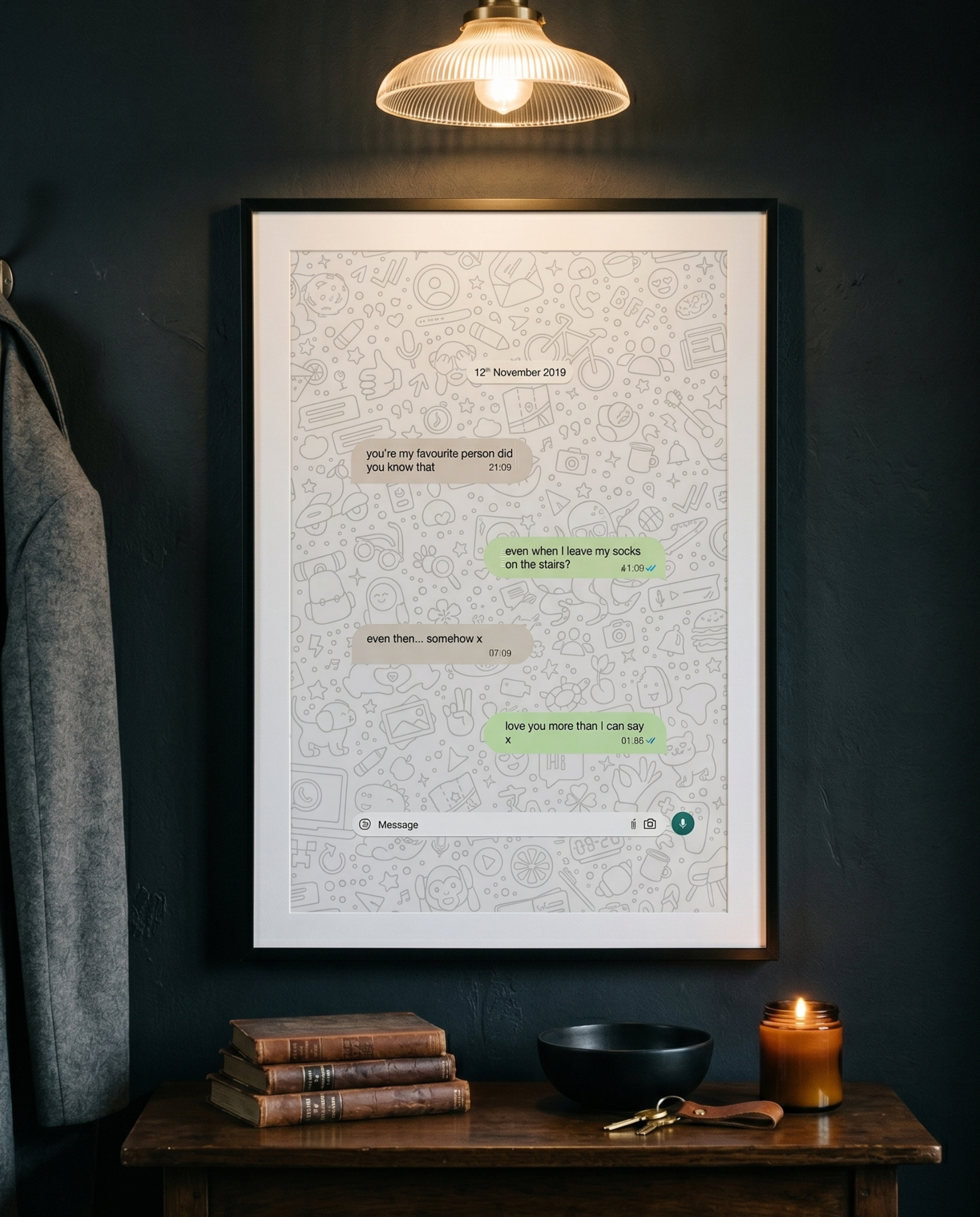 Framed text art on a dark wall with a wooden table and lamp.